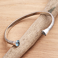 Blue topaz cuff bracelet, 'Precious Edge' - Hand Crafted Sterling Silver and Blue Topaz Cuff Bracelet