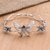 Garnet bangle bracelet, 'Windy Lotus' - Sterling Silver and Garnet Butterfly-Themed Bangle Bracelet