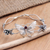 Garnet bangle bracelet, 'Windy Lotus' - Sterling Silver and Garnet Butterfly-Themed Bangle Bracelet
