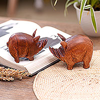 Wood statuettes, 'Piggy Brothers' (pair) - Artisan Crafted Suar Wood Pig Statuettes (Pair)
