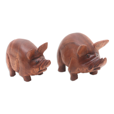 Wood statuettes, 'Piggy Brothers' (pair) - Artisan Crafted Suar Wood Pig Statuettes (Pair)