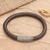 Leather and sterling silver pendant bracelet, 'Good News' - Woven Leather and Sterling Silver Pendant Bracelet
