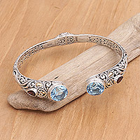 Gold-accented blue topaz and garnet cuff bracelet, 'Divine Blue'