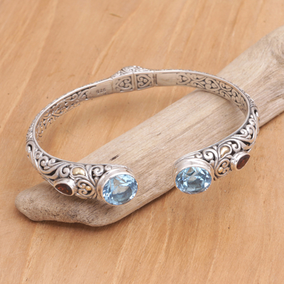 Gold-accented blue topaz and garnet cuff bracelet, 'Divine Blue' - Handmade Sterling Silver Blue Topaz Cuff Bracelet from Bali