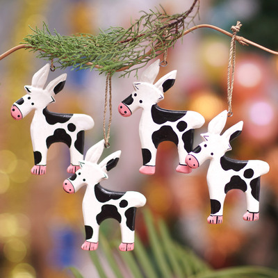 Wood ornaments, 'Winter Cows' (set of 4) - Set of 4 Hand-Painted Cow Ornaments Crafted from Wood