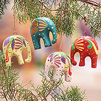 Wood ornaments, 'Happy Trunks' (set of 4) - Handcrafted Elephant Wood Ornaments from Bali (Set of 4)
