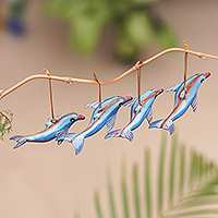 Wood ornaments, 'Joyful Flippers' (set of 4) - Handcrafted Jempinis Wood Dolphin Ornaments (Set of 4)
