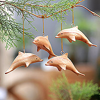 Wood ornaments, 'Marvelous Dolphins' (set of 4) - Hand-Carved Wood Dolphin Christmas Ornaments (Set of 4)