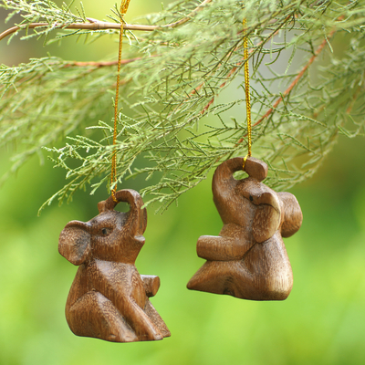 Wood ornaments, 'Giant Tenderness' (pair) - Pair of Suar Wood Baby Elephant Ornaments Carved in Bali