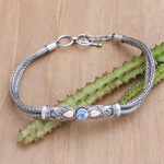 Gold-accented blue topaz pendant bracelet, 'Front to Back in Blue' - Blue Topaz Naga Chain Bracelet with Gold-Accented Pendant