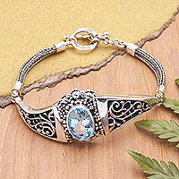 Blue topaz pendant bracelet, 'Penglipuran's Treasure' - Traditional Pendant Bracelet with Faceted 6-Carat Blue Topaz