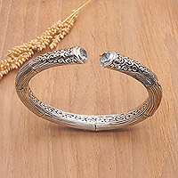 Blue topaz cuff bracelet, 'Loyal Bali' - Sterling Silver Cuff Bracelet with Faceted Blue Topaz Gems