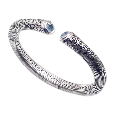 Blue topaz cuff bracelet, 'Loyal Bali' - Sterling Silver Cuff Bracelet with Faceted Blue Topaz Gems