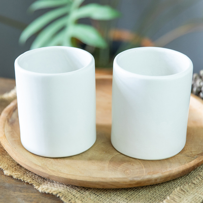 Ceramic cups, 'Enjoy the Day' (pair) - Set of 2 Handcrafted Minimalist White Ceramic Cups from Bali