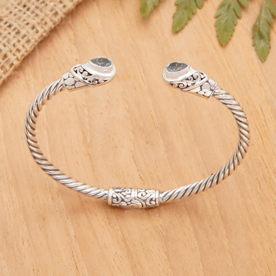 Blue topaz cuff bracelet, 'Loyal Fates' - Balinese Sterling Silver Cuff Bracelet with Blue Topaz Gems