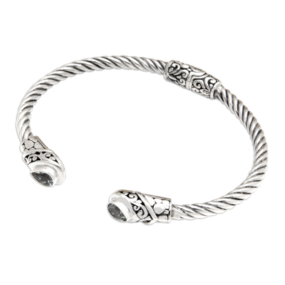 Blue topaz cuff bracelet, 'Loyal Fates' - Balinese Sterling Silver Cuff Bracelet with Blue Topaz Gems