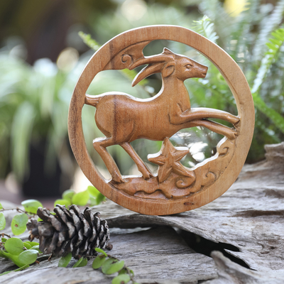 Wood relief panel, 'Capricorn Firmament' - Capricorn-Themed Hand-Carved Round Suar Wood Relief Panel