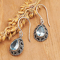 Blue topaz dangle earrings, 'Luxurious Winds in Blue' - Sterling Silver Dangle Earrings with Faceted Blue Topaz Gems
