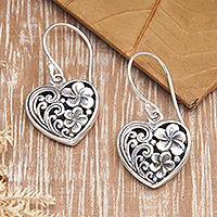 Sterling silver dangle earrings, 'Heart of Frangipani' - Sterling Silver Heart Dangle Earrings with Frangipani Motifs