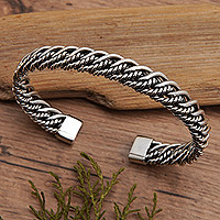 Sterling silver cuff bracelet, 'Supreme Encounters' - Polished Sterling Silver Cuff Bracelet with Rope Motifs