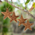 Wood ornaments, 'Morning Grace' (set of 4) - Set of 4 Traditional Star-Shaped Suar Wood Ornaments (image 2) thumbail