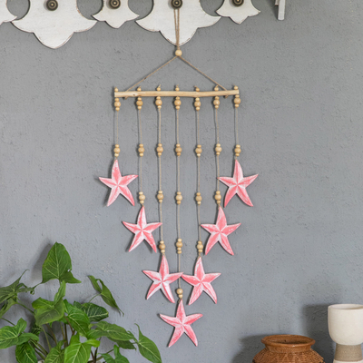 Wood wall hanging, 'Stunning Starfish' - Hand-Carved and Painted Pink Star-Themed Wood Wall Hanging