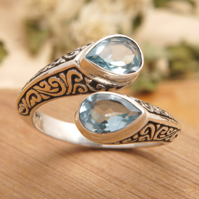 Blue topaz wrap ring, 'Two Marvels' - Sterling Silver Wrap Ring with Two Faceted Blue Topaz Stones