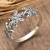 Sterling silver band ring, 'Starry Blooms' - Star-Inspired Floral Sterling Silver Band Ring from Bali