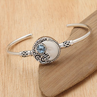 Blue topaz cuff bracelet, 'Sleeping Moon' - Two-Carat Faceted Blue Topaz Crescent Moon Cuff Bracelet