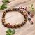 Men's multi-gemstone beaded pendant bracelet, 'Tridatu Protection' - Yoga Tridatu Men's Onyx Tiger's Eye Unakite Pendant Bracelet