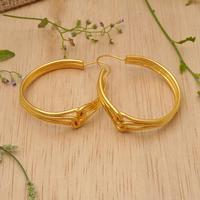 Gold-plated hoop earrings, 'Golden Bond' - Avant-Garde Polished 18k Gold-Plated Hoop Earrings from Bali