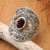 Garnet cocktail ring, 'Eye for Passion' - Balinese-Made Folk Art One-Carat Oval Garnet Cocktail Ring