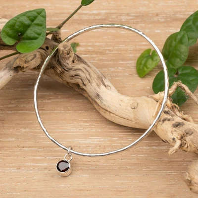 Garnet bangle pendant bracelet, 'Swaying Sparkle' - Hammered Silver Bangle Bracelet with Swaying Garnet Pendant