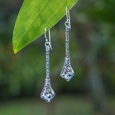 Gold-accented blue topaz dangle earrings, 'Balinese Serenity' - Folk Art-Themed Dangle Earrings with Faceted Blue Topaz Gems