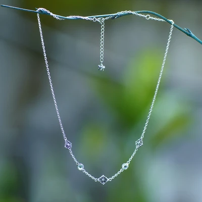 Blue topaz station necklace, 'Balinese Plumeria' - Floral-Themed Blue Topaz Sterling Silver Station Necklace