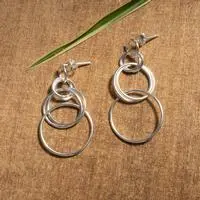 Sterling silver dangle earrings, 'Intertwined Hoops' - Intertwined Circle-Themed Sterling Silver Dangle Earrings