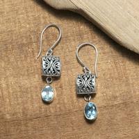 Blue topaz dangle earrings, 'Peaceful Horizon' - Balinese Folk Art-Themed Faceted Blue Topaz Dangle Earrings