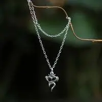 Blue topaz pendant necklace, 'Om of Serenity' - Om-Themed Birthstone Blue Topaz Pendant Necklace from Bali