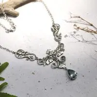 Blue topaz pendant necklace, 'Lotus of the Loyal' - Floral and Leafy 3-Carat Faceted Blue Topaz Pendant Necklace
