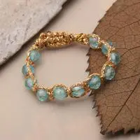 Blue topaz beaded band ring, 'Stunning Azure' - Faceted Blue Topaz Beaded Band Ring with Golden-Hued Cords