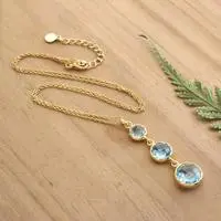 Gold-plated blue topaz pendant necklace, 'Soothing Glamour' - Gold-Plated Pendant Necklace with 3 Round Blue Topaz Stones