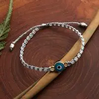 Gold-accented aquamarine and resin macrame beaded pendant bracelet, 'Seeing Eye' - Evil Eye Gold-Accented Aquamarine Resin Macrame Bracelet