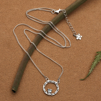 Blue topaz pendant necklace, 'Botanical Radiance' - Blue Topaz Silver Necklace with Circular Leaf-Themed Pendant