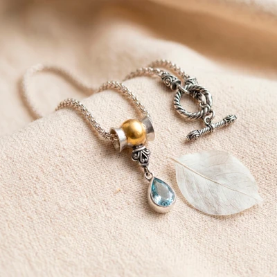 Gold-accented blue topaz pendant necklace, 'Sun and Ice' - Gold-Accented Blue Topaz Pendant Necklace with Popcorn Chain