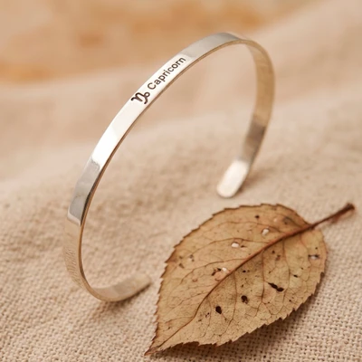 Sterling silver cuff bracelet, 'Capricorn Prestige' - Unisex Polished Capricorn-Themed Sterling Silver Bracelet