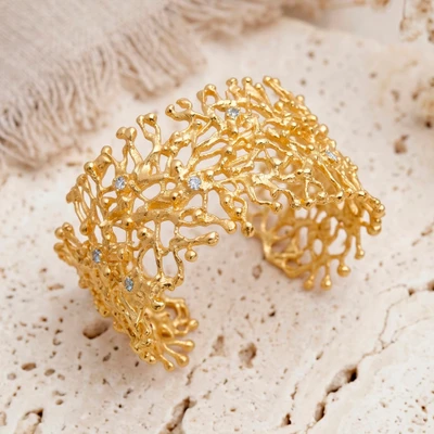 Gold-plated blue topaz cuff bracelet, 'Angelic Beginnings' - Birthstone 1-Carat Faceted Round Blue Topaz Cuff Bracelet