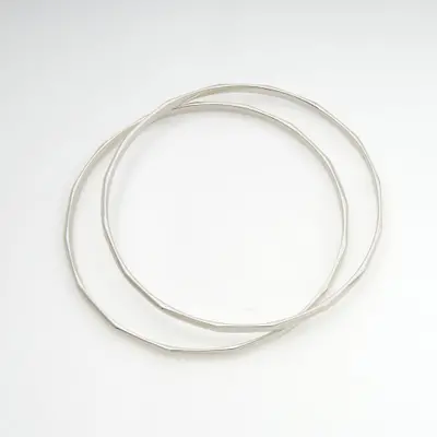 Sterling silver bangle bracelets, 'Shining Geometry' (pair) - Pair of Silver Bangle Bracelets with Geometric Silhouette
