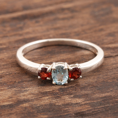 Garnet and blue topaz 3-stone ring, 'Passionate Embrace' - Blue Topaz and Garnet Ring