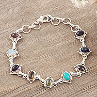 Lapis and rainbow moonstone tennis bracelet, 'Color Medley' - Oval Gemstone Linked Bracelet with Garnet, Amethyst, & Lapis