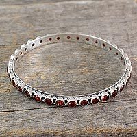 Garnet bangle bracelet, 'Love's Energy' - 15-carat Garnet Fair Trade Silver Bangle Bracelet from India